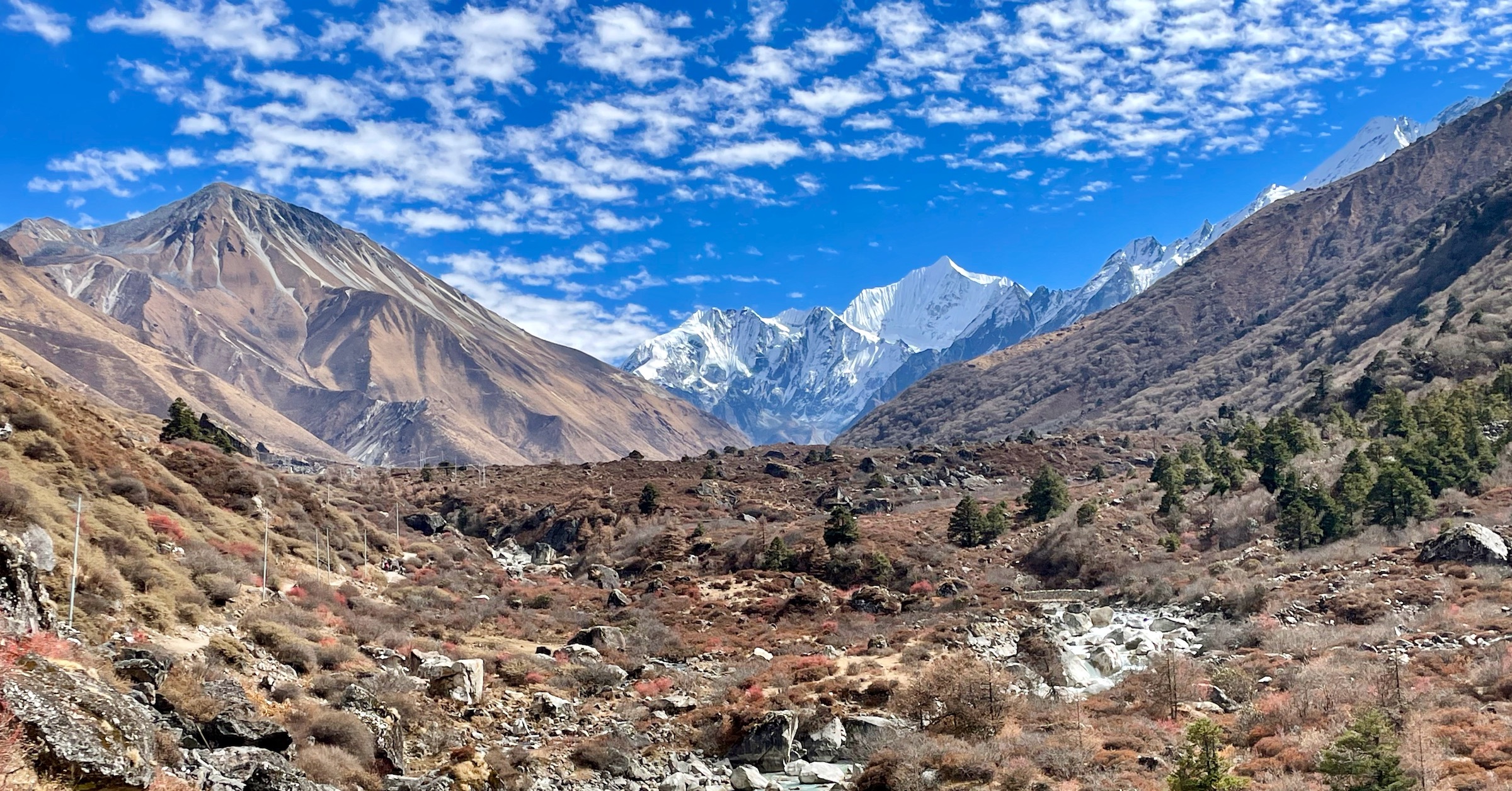 Snow capped peaks at the very bottom of Langtang Valley as seen from the path to Kyanjin