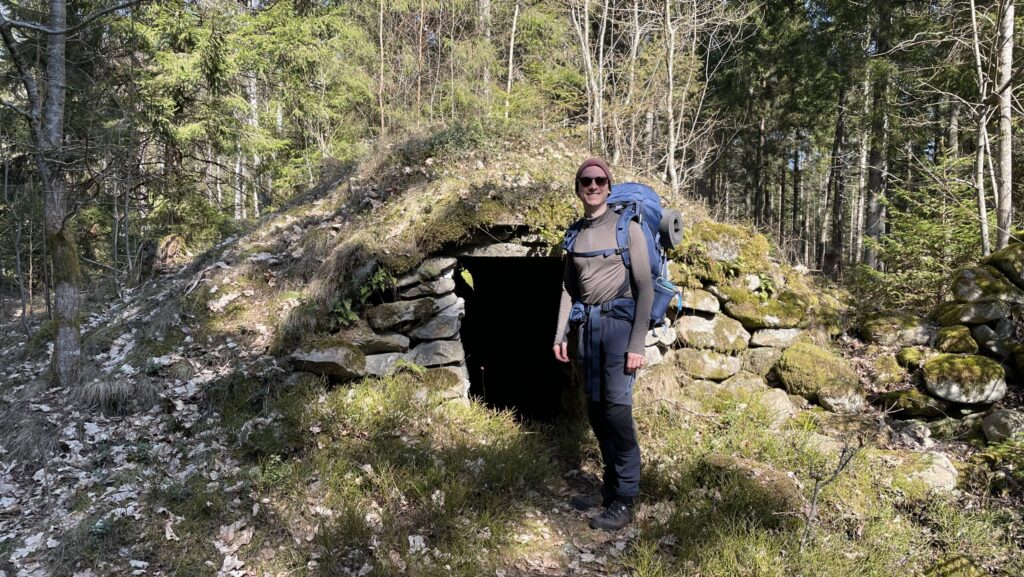 Man in front of medieval ruin of house in Sweden